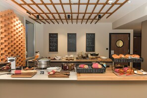 A breakfast buffet with various food items and condiments. - The Originals Boutique Hotel Rivella (Clisson)