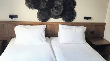 Premium bedding, pillow-top beds, desk, laptop workspace