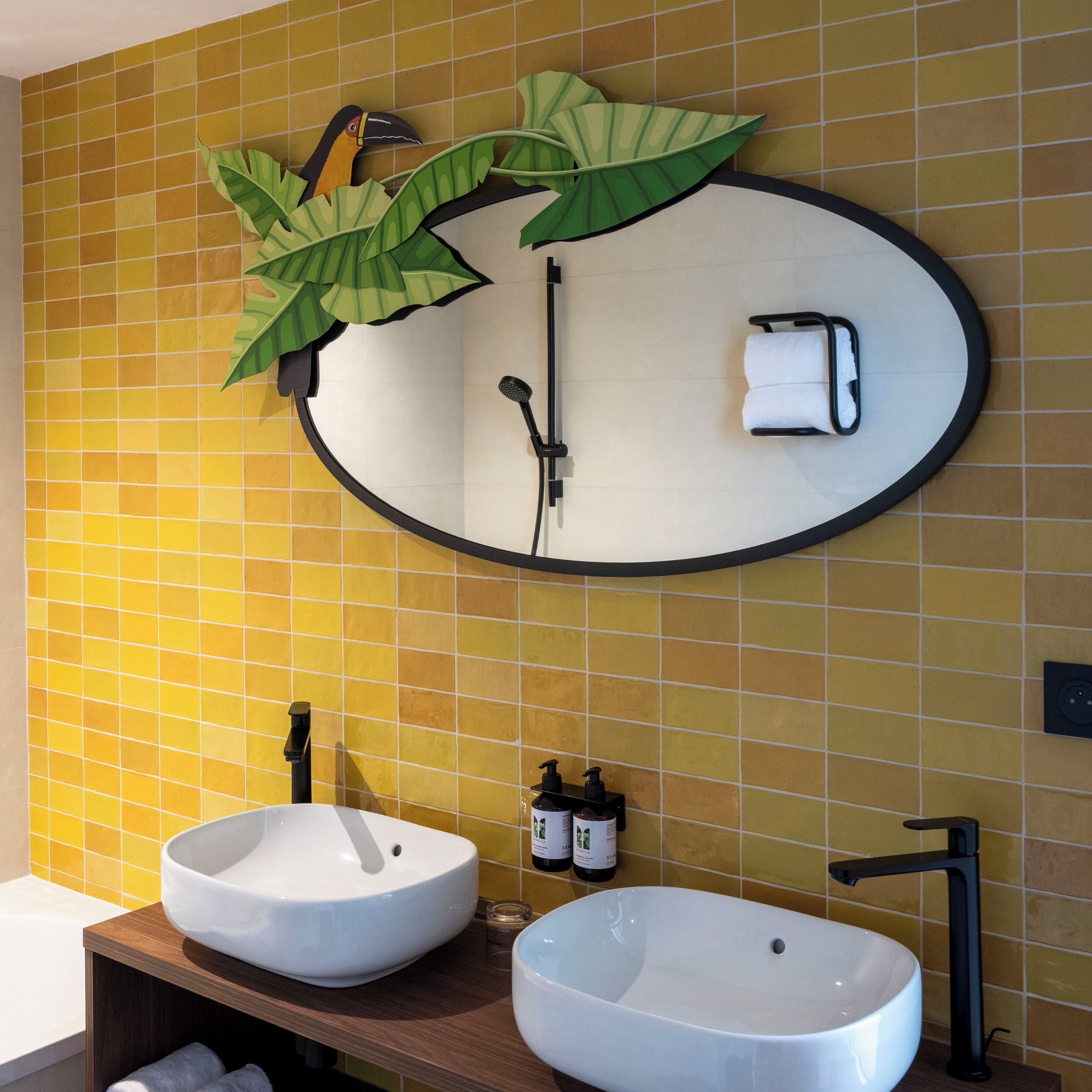 A bathroom with two sinks, a towel rack, and a mirror.
