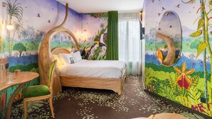 A bedroom with a bed, a chair, a table, and a mirror. - The Originals Boutique Hotel Rivella (Clisson)
