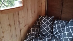A wooden room with a bed, a window, and a door. - Llandovery - Cabin - Sleeps 2 - Parking - Garden (Llandovery)