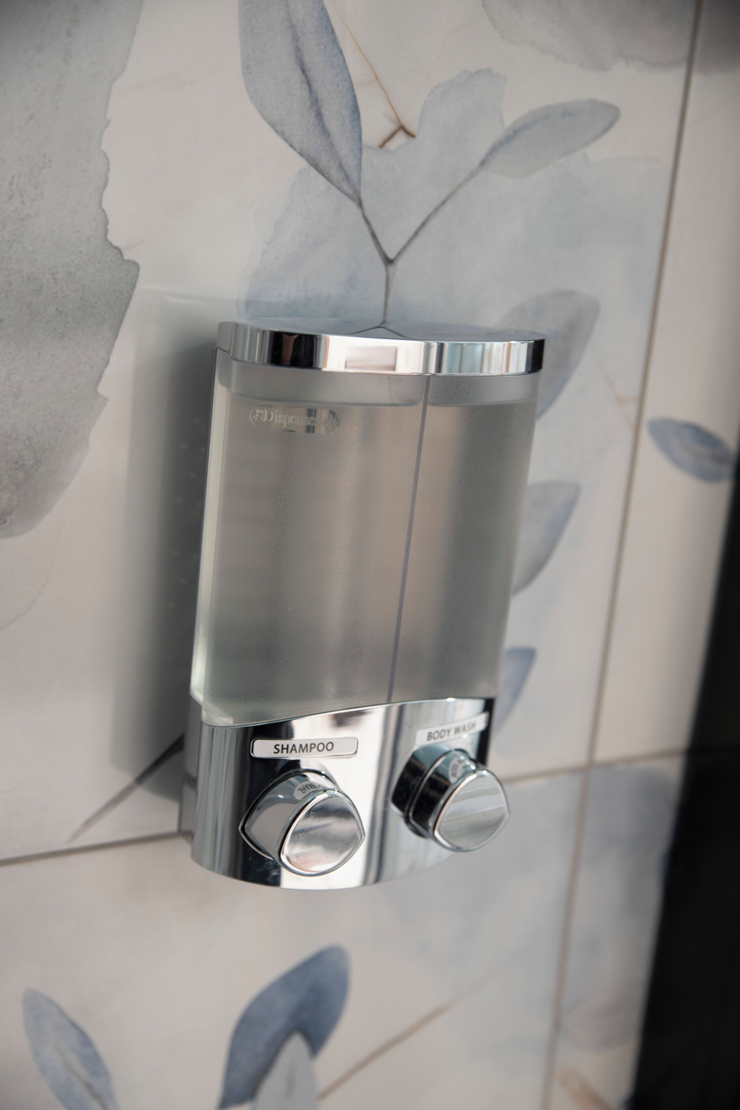 A modern bathroom with a built-in shampoo dispenser.