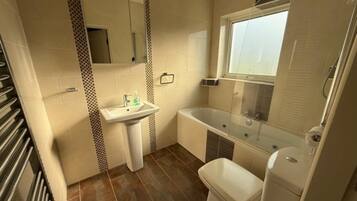 Combined shower/bathtub, deep-soaking bathtub, hair dryer, towels