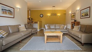 A living room with two sofas, a coffee table, and a rug.