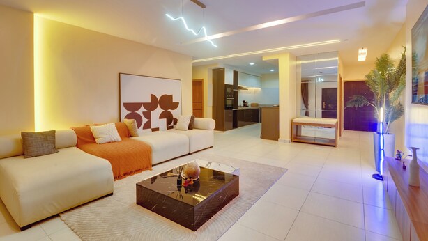 A modern living room with a sofa, coffee table, and a dining area. - 1-Bedroom Apartment in Lekki off Admiralty (Lekki Phase 1)