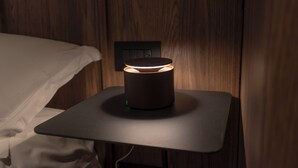 A bedside table with a modern lamp and a power outlet. - Le Torri Suites (Bergamo)