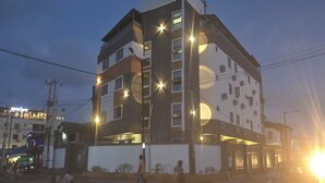 A multi-story building with illuminated windows and a ground-level entrance. - Preserve Hotel Ilupeju (Lagos)