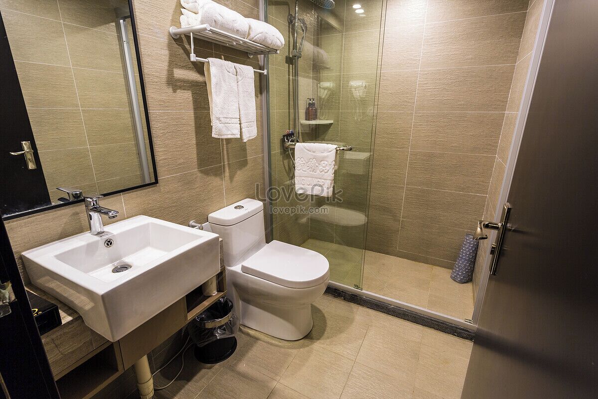 A modern bathroom with a sink, toilet, and glass-enclosed shower.