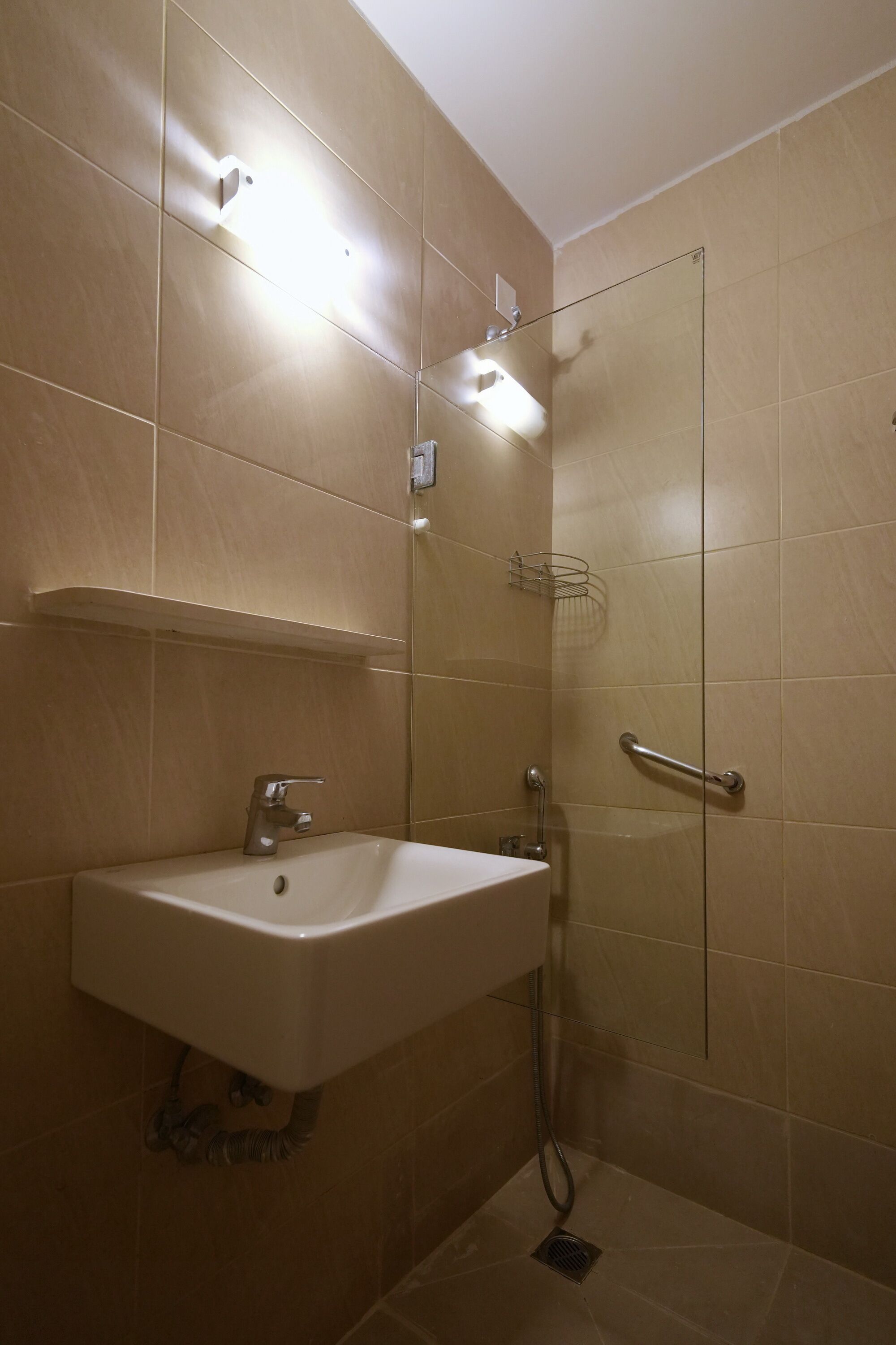 A bathroom with a sink, mirror, and shower.