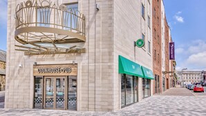 A building with a 'Cookhouse Pub' sign, a green awning, and a 'Three Piers' sign. - Premier Inn Blackpool - North Pier (Blackpool)