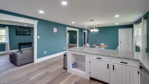 A spacious kitchen with white cabinets, a granite countertop, and a built-in dishwasher. - Walk to Stores: Home in Historic Shepherdstown! (Shepherdstown)