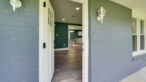 A hallway with a door leading to a dining area. - Walk to Stores: Home in Historic Shepherdstown! (Shepherdstown)