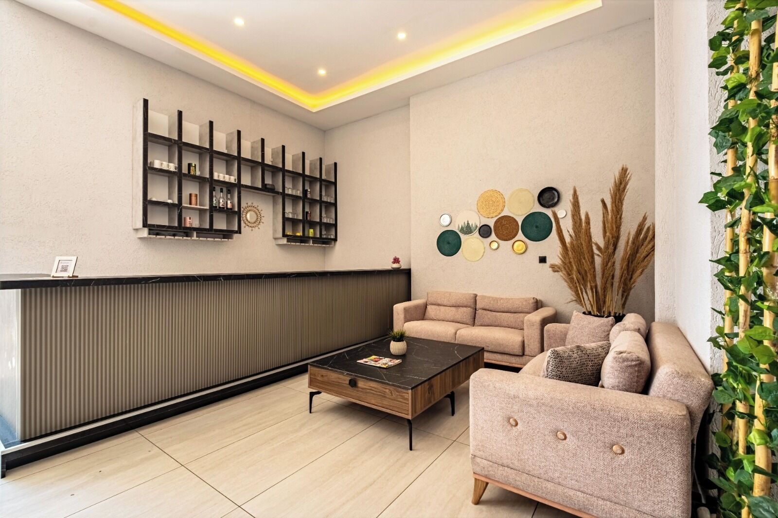 A modern reception area with a sofa, a coffee table, and a wall-mounted shelf unit.