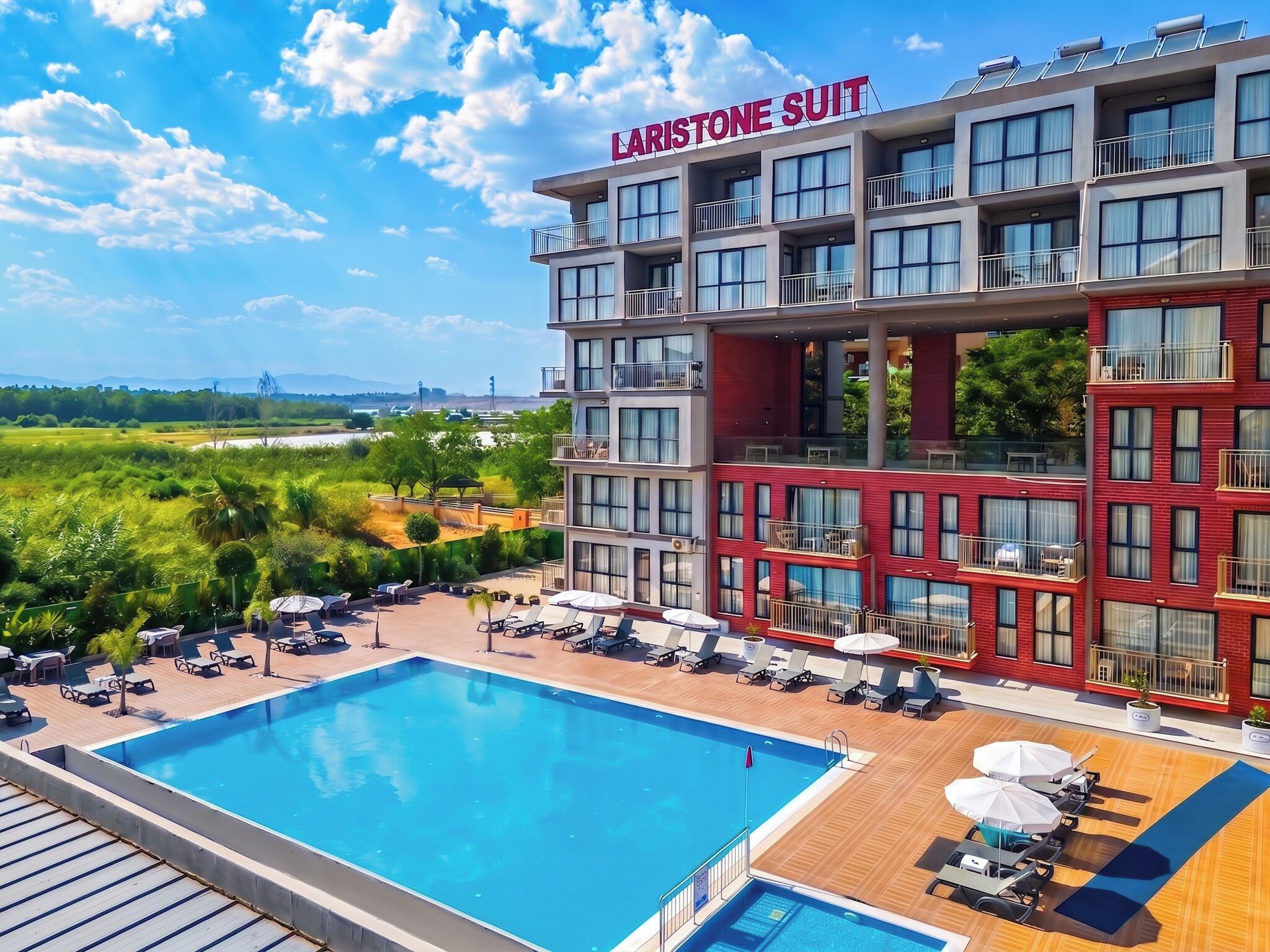 A hotel with a pool, multiple balconies, and a view of the landscape.
