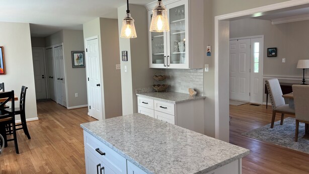 A kitchen with white cabinets, a marble countertop, and pendant lighting. - Charming 4-bedroom House on beautiful farm in Clear Brook with lovely views (Clear Brook)