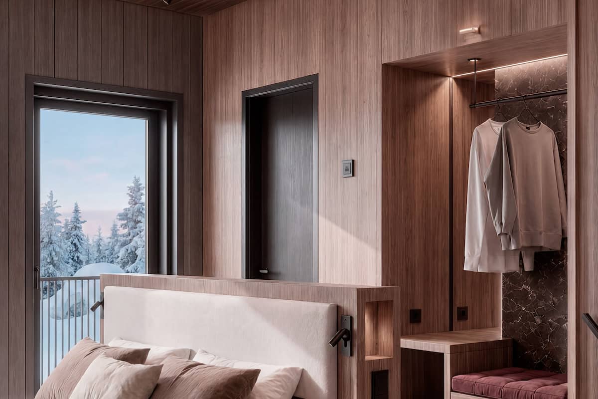 A bedroom with a bed, a wardrobe, and a window with a view of trees.