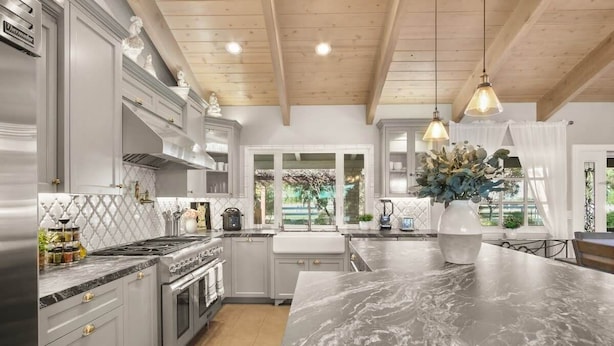 A modern kitchen with grey cabinetry, a marble island, and pendant lighting. - @ Marbella Lane - Alpaca Farm House l Pool (Modesto)