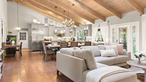 A spacious living area with a wooden ceiling, a dining table, and a sofa. - @ Marbella Lane - Alpaca Farm House l Pool (Modesto)