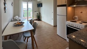 A modern kitchen with a dining area, wooden cabinets, and a built-in oven.