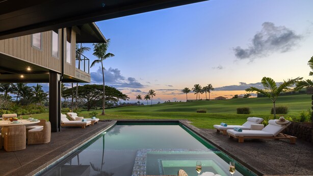 A poolside area with lounge chairs, a dining setup, and a view of a golf course at sunset. - Luxury 6BR Hale o ka Nene Estate w/ Pool/Spa & Golf Views, Near Beach (Koloa)