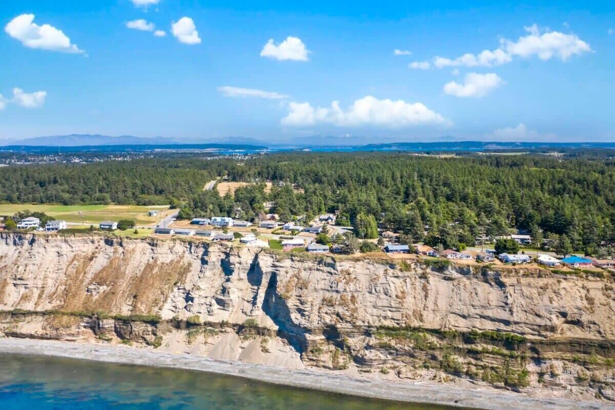 A coastal town with houses on a cliff overlooking the sea.