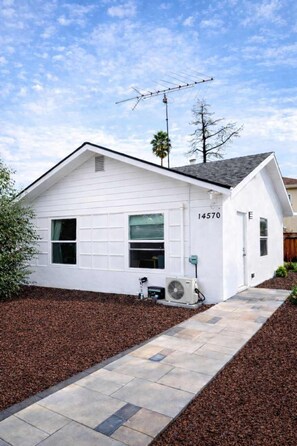 A single-story white house with a garage, numbered 14570, and a satellite dish on the roof. - @ Marbella Lane - Spacious 2BR Home Near Westgate  (San Jose)