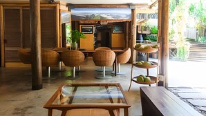 Un interior amplio con muebles de madera, una mesa de vidrio y vistas a un paisaje nevado a través de amplias ventanas.