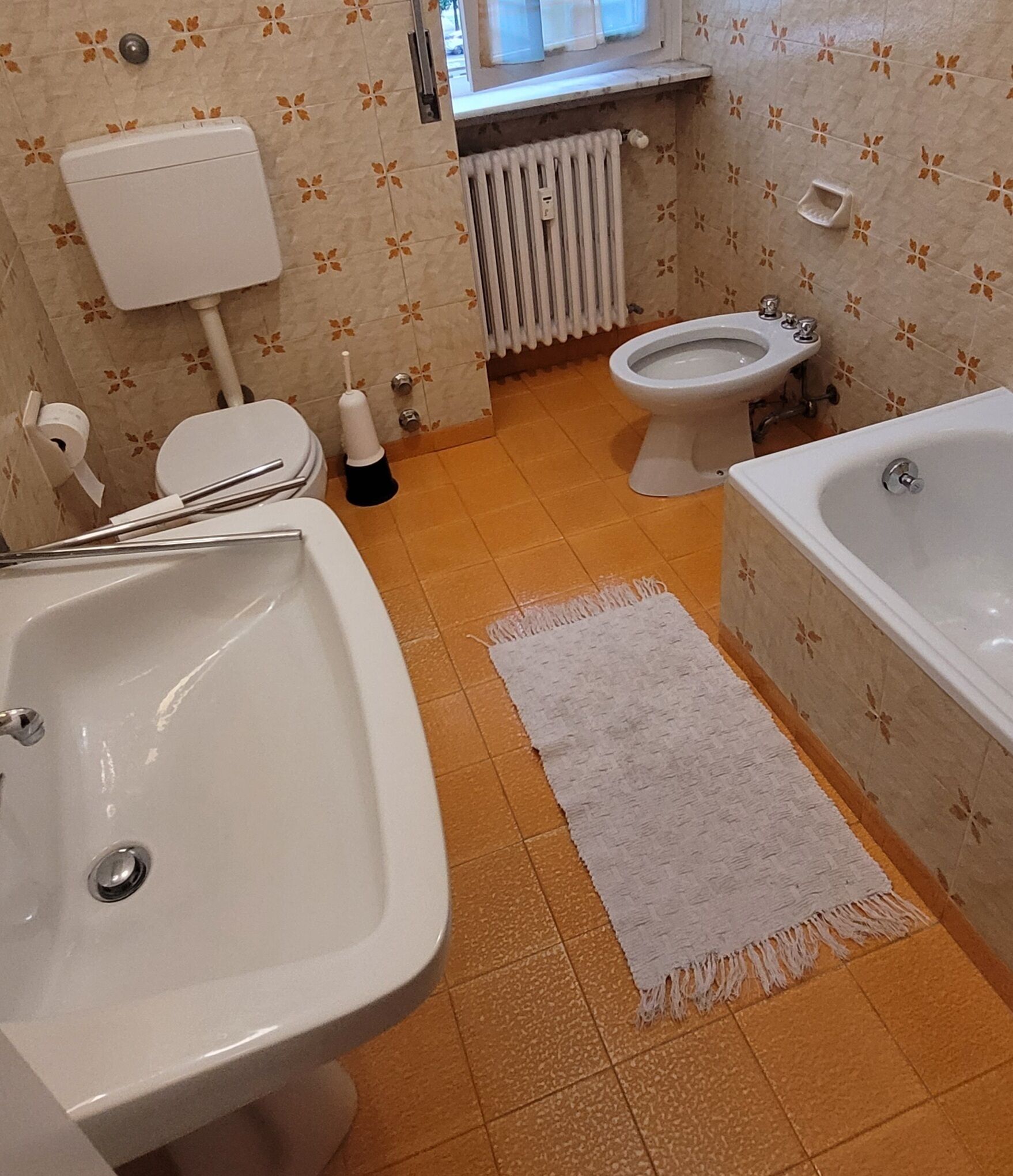 A bathroom with a sink, toilet, and bathtub.