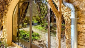 A window with a view of a garden area with trees and a pathway. - Stunning home in Sabran with heated swimming pool (Sabran)