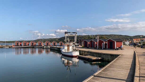 A calm harbor with a dock, a boat, and several red buildings along the waterfront. - 4 bedroom nice home in Båstad (Båstad)