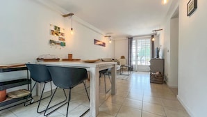 A modern kitchen with a central island, bar stools, and pendant lighting. - Gorgeous home in Saint Pons La Calm (Saint Pons La Calm)