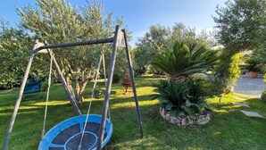 A backyard with a swing set and a trampoline. - Beautiful home in Kastel Stari (Kastel Stari)