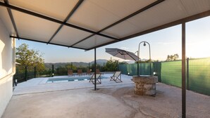 An outdoor pool area with a covered patio, lounge chairs, and a view of mountains. - Awesome home in Blato na Cetini (Blato na Cetini)
