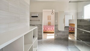A modern, well-lit bedroom with a large bed, a bedside table, and a wardrobe. - Comfortable, pittoresques (Combas)