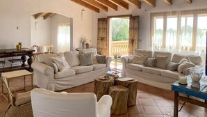 A spacious living area with two sofas, a dining table, and a coffee table. - Nice home in Son Servera (Son Servera)