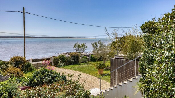 A coastal property with a view of the sea, a garden with various plants, and a staircase leading to a deck. - Awesome home in Saint-Trojan-les-Bains (Saint-Trojan-les-Bains)