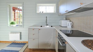 A compact kitchen with a sink, microwave, and stove. There are two windows providing natural light and a view of the outdoors. - 2 bEdroom gorgeous home in Ed (Ed)
