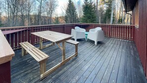 A wooden deck with a picnic table and white chairs. - 2 bEdroom gorgeous home in Ed (Ed)