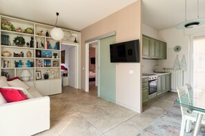 A modern apartment with a living room, kitchen, and dining area.