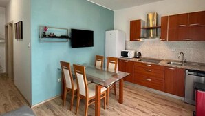 A modern kitchen with wooden cabinets, a stainless steel range hood, a microwave, and a sink. - Lovely apartment in Vodice with WiFi (Vodice)