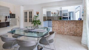 A modern kitchen with grey cabinets, a tiled backsplash, and a built-in oven.