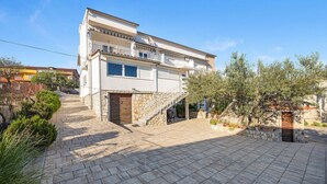 A two-story building with a stone staircase leading to a wooden door. - Gorgeous apartment in Pirovac with WiFi (Pirovac)