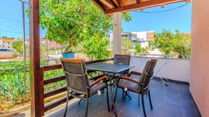 An outdoor patio with a table and chairs, a pergola, and a view of the surrounding area. - Beautiful apartment in Vir with WiFi (Vir)