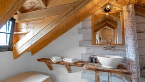 A rustic bathroom with a wooden vanity, a large mirror, and a white sink. - Awesome home in Pirovac with WiFi (Pirovac)