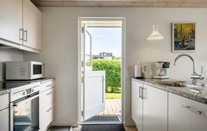 Fridge, stovetop, dishwasher, coffee/tea maker