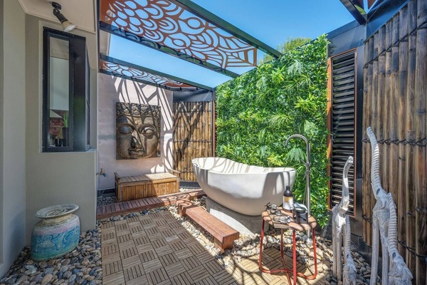 Slip into the soaking tub framed by bamboo fencing and tropical greenery, an idyllic setting for sunset soaks or quiet moments of morning mindfulness.