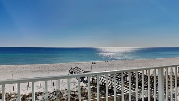 A beach view from a balcony with a wooden deck and a railing. - Perdido Skye #24 by Southern Vacation Rentals (Pensacola)