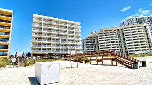 A beachfront hotel with multiple high-rise buildings, a sandy beach, and a wooden boardwalk. - Perdido Skye #24 by Southern Vacation Rentals (Pensacola)