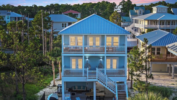A multi-story beachfront house with a pool, outdoor seating, and a staircase leading to a balcony. - Cape San Blas Gulf Views, Private Pool, Steps to Beach (Port St. Joe)