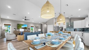 A modern kitchen with white cabinets, a built-in oven, and a stainless steel range hood. - Cape San Blas Gulf Views, Private Pool, Steps to Beach (Port St. Joe)